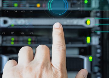 hand of man  operating server cabinet via digital control panel in data center
